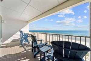 a balcony with chairs and a view of the ocean at Sea Glass 404 by Youngs Suncoast in Gulf Shores