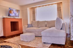 a living room with a couch and a chair at The Haven House in Nairobi