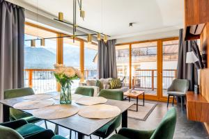 a living room with a table and chairs at Słoneczne Polany by Apart Concept Podhale in Kościelisko