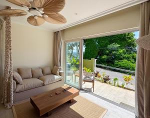 a living room with a couch and a table at Cocoon Self-Catering Apartments in Anse a La Mouche