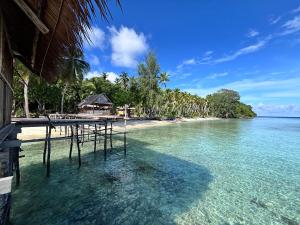 a view of a beach with a pier in the water at Saubaryam Home stay in Fam