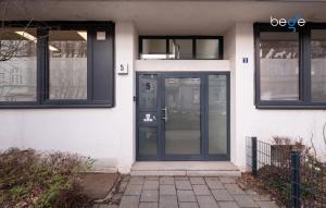 a front door of a white building with black windows at BEGE APARTMENTS LoftWork in Lüdenscheid