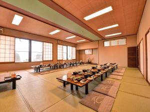 a large room with tables and chairs in it at Takumi Kanko Hotel in Minamichita +35 photos