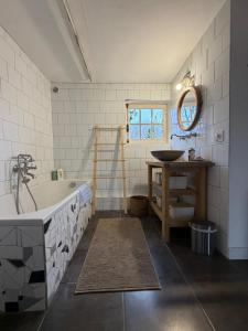 a bathroom with a bath tub and a sink at Gite des Trévignes in Cambremer +30 photos
