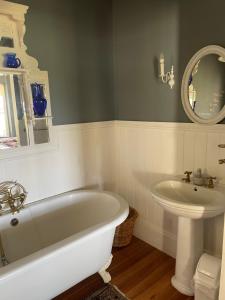a bathroom with a white tub and a sink at Beside Still Waters in Wilderness +71 photos