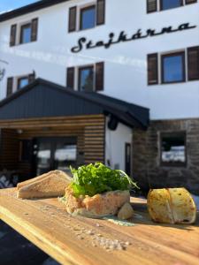 a wooden cutting board with bread and vegetables on it at Stejkárna Špičák in Špičák