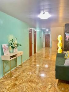 a living room with a couch and a table at RedDoorz at Urban Hotel in Zamboanga