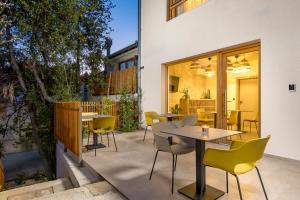a patio with tables and chairs and a building at Pula Residence in Pula