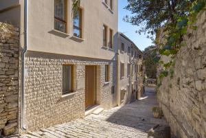 an alley with a building with yellow doors at Pula Residence in Pula