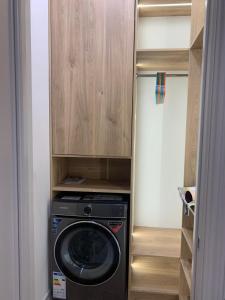 a washer and dryer in a small closet at Eleon apartment in Bishkek +2 photos