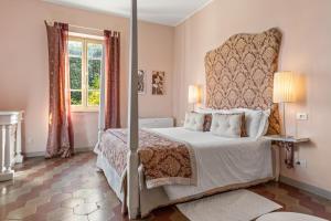 a bedroom with a large bed and a window at Fontelunga Hotel & Villas in Pozzo +61 photos