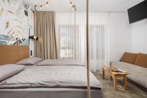 a bedroom with a hanging bed and a couch at Pula Residence in Pula