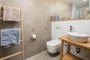 a bathroom with a white toilet and a sink at Pula Residence in Pula +41 photos