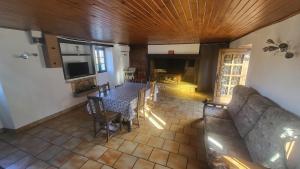 a living room with a table and a couch at Coeur de Koss Climatisé in Blars