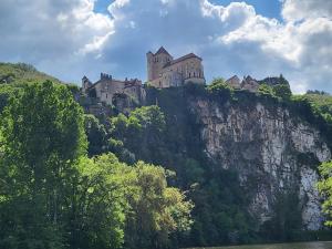 a castle sitting on top of a mountain at Coeur de Koss Climatisé in Blars