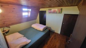 a room with a bed with two pillows on it at Coeur de Koss Climatisé in Blars
