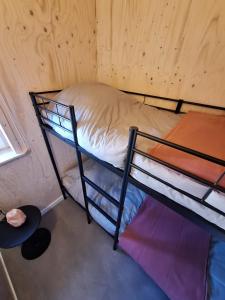 a small room with two bunk beds in it at Zee aan Geluk in Sint Maartensvlotbrug +26 photos