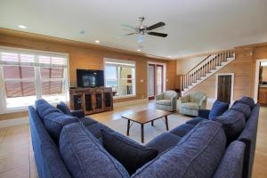 a living room with a large blue couch and a table at Summer Salt 3 East by Youngs Suncoast in Orange Beach