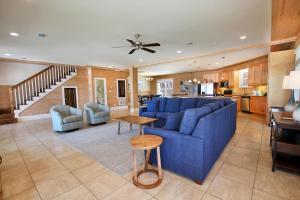 a living room with a blue couch and a table at Summer Salt 3 East by Youngs Suncoast in Orange Beach