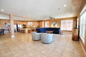 a living room with a blue couch and a kitchen at Summer Salt 3 East by Youngs Suncoast in Orange Beach +95 photos
