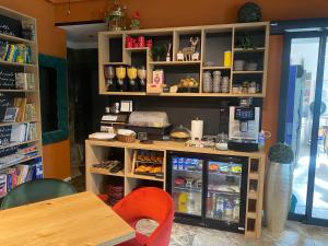 a coffee shop with a counter and a table and chairs at Boutique hotel ZBILJE in Zbilje