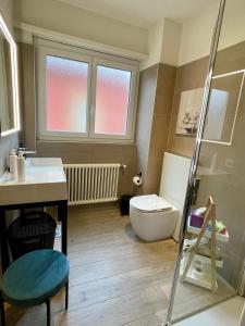 a bathroom with a toilet and a sink at RELAX Glicine Apartment in Locarno