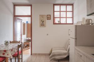 a kitchen with a white refrigerator and a table at Apartments Lea in Prizba