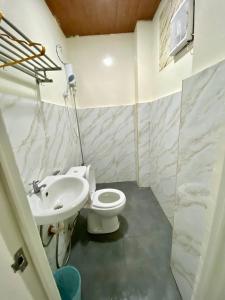 a bathroom with a toilet and a sink at RedDoorz at Urban Hotel in Zamboanga +39 photos