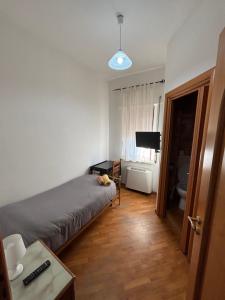 a bedroom with a bed and a desk and a television at Casa Alighieri in Montalto Uffugo +7 photos