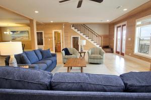 a living room with a blue couch and chairs at Summer Salt 4 West by Youngs Suncoast in Orange Beach