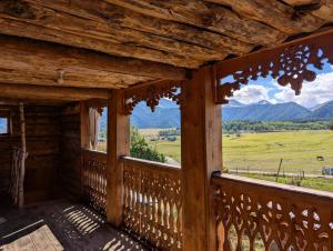 a view from the porch of a cabin with a view of mountains at Guesthouse Javakhe in Omalo