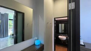 a bathroom with a sink and a mirror at Bulan Anda Resort in Ban Hua Laem +29 photos