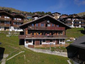 a large building with balconies on the side of it at Chalet apartment with Mountain View in Bettmeralp