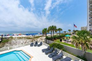 a swimming pool with chaise lounge chairs and the beach at Summer Salt West by Youngs Suncoast in Orange Beach +53 photos
