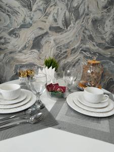 a table with plates and wine glasses on it at Абая in Temirtaū