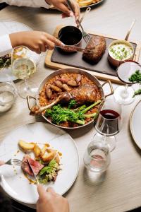 a table with a thanksgivinggiving meal with meat and vegetables at EPIC SANA Lisboa Hotel in Lisbon