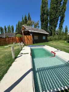 a swimming pool in front of a house at Cabanas Embau in San Rafael