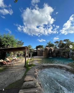 a swimming pool in front of a water park at Pousada Caminho Das Cachoeiras in Sao Jorge