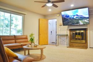 a living room with a couch and a flat screen tv at Exclusive 2B1B Prime Location in Sylvan Lake