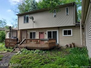 a house with a porch and a fence at Exclusive 2B1B Prime Location in Sylvan Lake