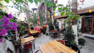an outdoor patio with tables and chairs and flowers at BAT Apart Otel in Antalya