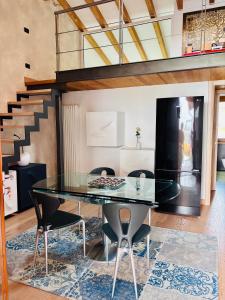 a dining room with a glass table and chairs at Lazise Suite in Lazise