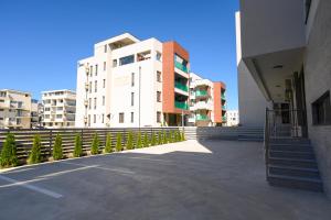 a large white building with stairs in front of it at Hotel Letos Mamaia Nord in Mamaia Sat/Năvodari