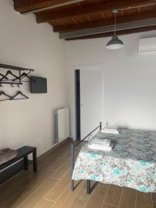 a white room with a bed and a table at Antico Borgo in Ancona +8 photos