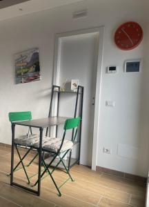 a table and chairs in a room with a clock at Antico Borgo in Ancona