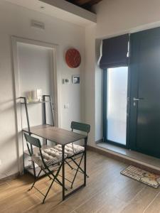a dining room with a table and chairs and a clock at Antico Borgo in Ancona