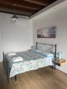 a bedroom with a bed and a table with a lamp at Antico Borgo in Ancona