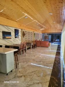 a large room with a table and chairs in it at Shabran Pearl Oasis - Family Garden House - Ailəvi Bağ Evi in Surra