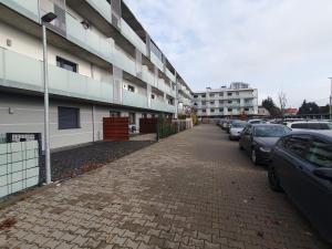 a parking lot with cars parked next to a building at Apartament Number One NOVA WOZOWNIA in Leszno