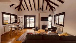 a living room with a couch and a table at Mountain View Retreat Mionica in Kosjeric
